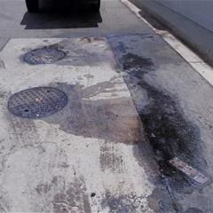 Grease entering a storm inlet from an overflow at a restaurant.