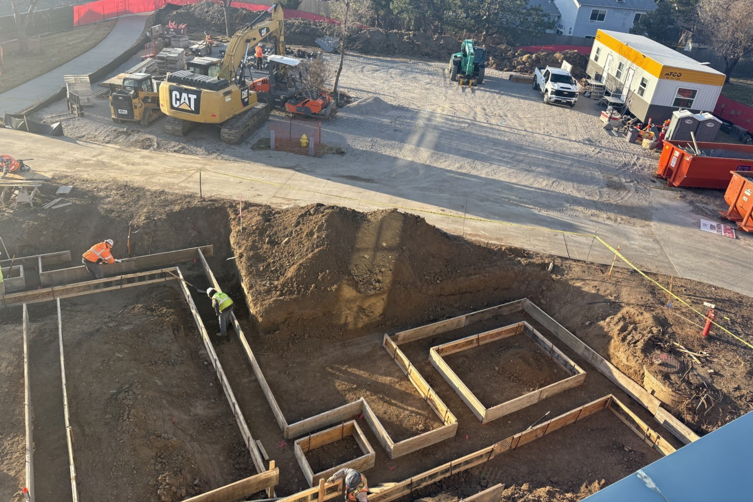 overlooking from above recreation center construction of expansion project with construction workers
