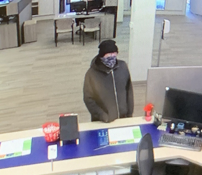 A male suspect dressed in black wearing a mask