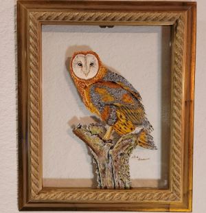 Painting of owl on clear glass in a gold frame. 