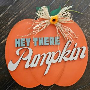 Handmade pumpkin door hanger reading \"Hey there, pumpkin\"