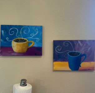 Two paintings of mugs with coffee in them. 
